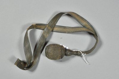 a small metal object with a cord attached to it