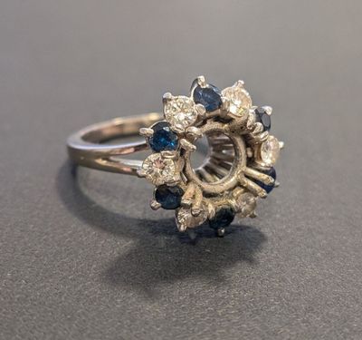 an image of a diamond and sapphire ring on a table