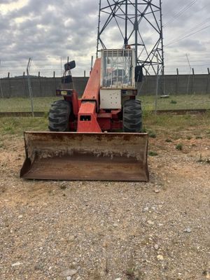 a tractor that is sitting in the dirt
