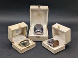 four pieces of jewelry are in a box on a table
