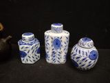 three blue and white vases sitting next to each other