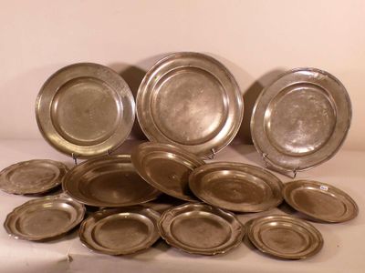 beaucoup d'assiettes en argent posées sur une table