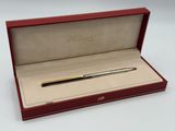 an image of a pen in a red box on a white surface