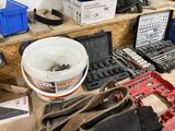 a bucket of tools sitting on a table next to other tools