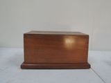 a small wooden box with a lid on a table