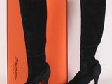 black sued high heel boots with orange box on white background