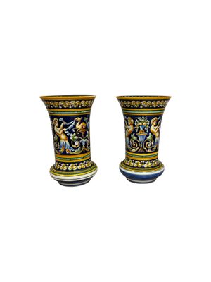 pair of ceramic vases with colorful designs on them on a white background