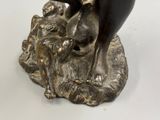 a statue of a man riding a horse on top of a rock