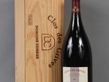 a bottle of wine sitting next to a wooden box on a table