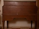 a small wooden desk with a mirror on top of it