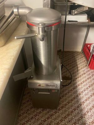 stainless steel blender sitting on top of a counter in a kitchen
