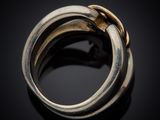 a close up of a gold ring on a black surface