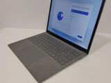 a laptop that is sitting on a table with a keyboard