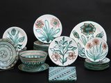 many plates and bowls with designs on them on a table