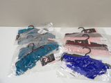 four pieces of luggage in plastic bags on a table