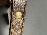 a close up of a purse with a keychain on it