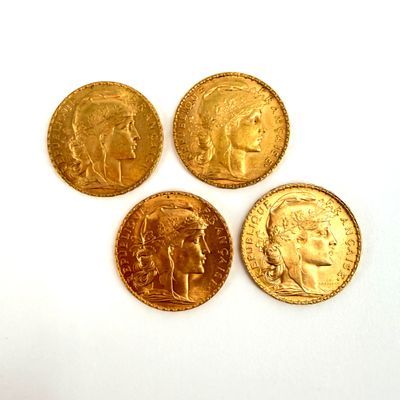 four different types of gold coins on a white surface