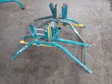a green and yellow machine that is sitting on the ground