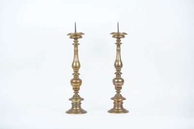 pair of antique brass candlesticks on a white background