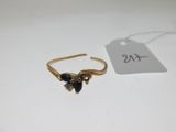 un gros plan d'une bague en or sertie de pierres noires