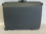 a gray suitcase with wheels on a white surface