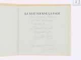 an open book with writing on it on a white surface