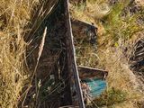 a boat that is sitting in the grass on the side of a hill