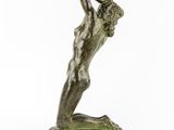 a bronze statue of a woman holding a ball