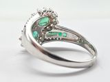 an image of a close up of a ring with a green stone