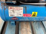 a blue air compressor sitting on top of a pallet