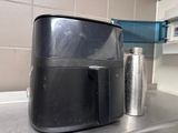 a black air fryer sitting on a counter in a kitchen