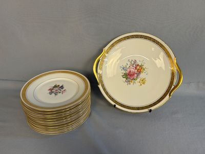 a set of six plates with gold rims and flowers on them
