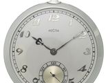 a close up of a pocket watch on a white background