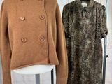 two coats on display on a stand in a room