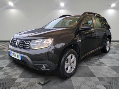 the front of a grey dacia parked on a checkered floor