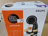 packaging of a coffee machine sitting on top of a cardboard box