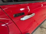 a close up of a car door handle with a sticker on it