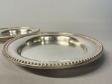 pair of silver plate with beaded rims on a table
