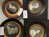 four framed pictures of people in different styles and sizes on a table