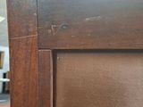a close up of a wooden cabinet with a brown door