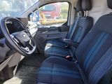 the interior of a van with blue seats and a steering wheel