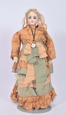 an image of a doll of a woman wearing a dress and a necklace