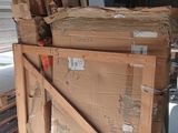 a large pile of cardboard sitting on a pallet in a warehouse