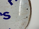 a white clock with blue letters on it on a white wall