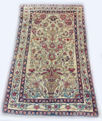 un tapis persan antique avec un motif floral sur fond blanc