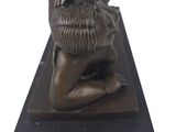 statue of a woman with a basket on her head on a black base