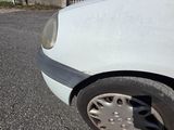 a white car that is parked on the side of the road