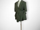 mannequin with green jacket and red beret on display