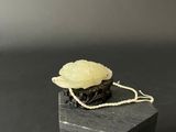 chinese carved jade flower on a black box with rope