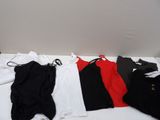 un lit sur lequel sont posés tout un tas de vêtements